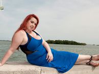 Big Redhead Woman In Dress By The Water - chunky reddish lady